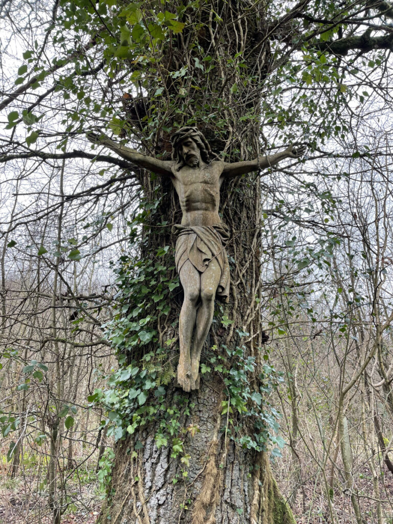 Wooden crucifixion carving on a tree